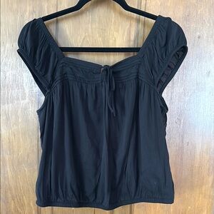 Black blouse with off or on shoulder look.